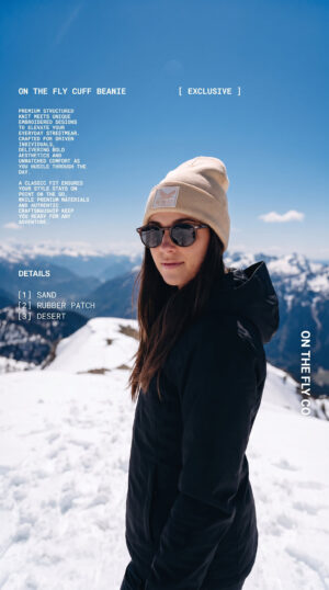 women's tan On The Fly cuff beanie with bird rubber patch logo